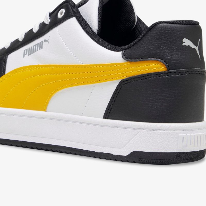 Moderner Sneaker mit dynamischem Design in Weiß, Schwarz und Gelb für optimalen Komfort und Stil.