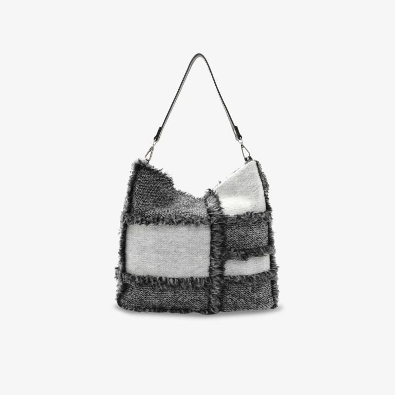 Stylische Tasche mit Fransen und kontrastierendem schwarz-weißem Design.