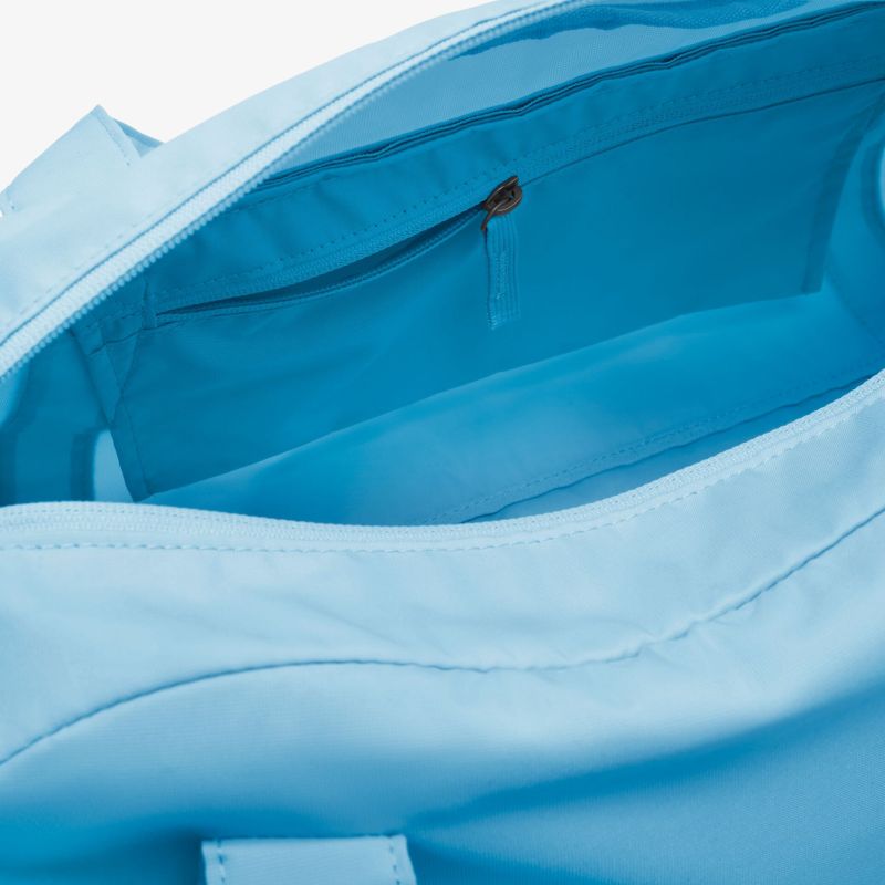 Detailaufnahme einer stilvollen, lichtblauen Tasche mit geräumigem Innenfach und Reißverschluss.