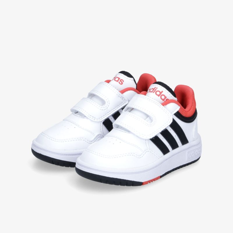 Stylische weiße Sneaker mit Klettverschluss, roten Akzenten und markanten schwarzen Streifen, ideal für Alltag und Sport.