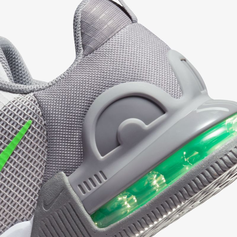 Grauer Sportschuh mit sichtbarer grüner Dämpfung und modernem Design für optimalen Komfort und Stil.