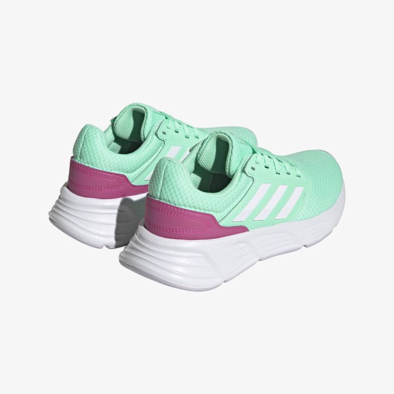 Mintgrüne Sportschuhe mit weißen Streifen und pinkem Akzent, ideal für komfortable und stilvolle Bewegung.