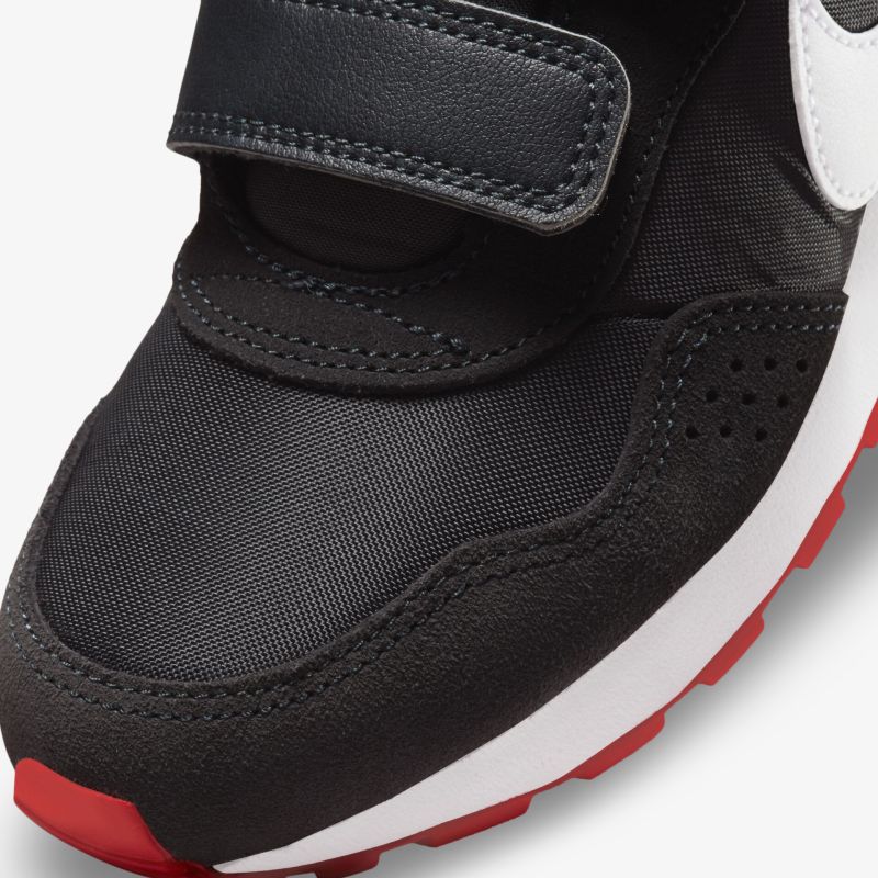 Stylish black sneaker with Velcro closure and red accents for a secure, comfortable fit and modern look.