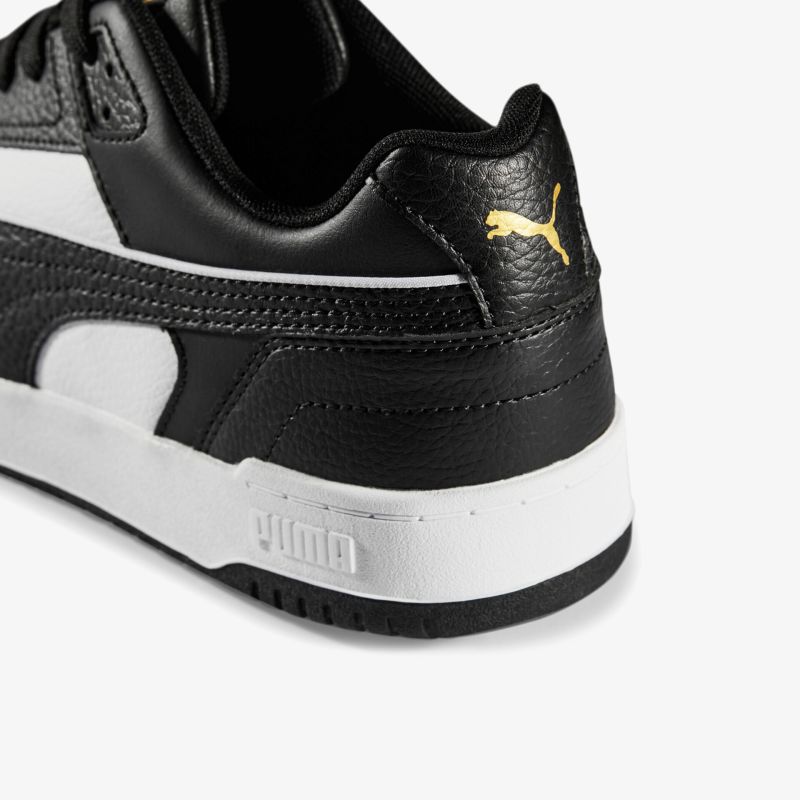 Schwarzer und weißer Lederschuh mit sportlichem Design und markantem Markenlogo, ideal für Alltag und Sport.