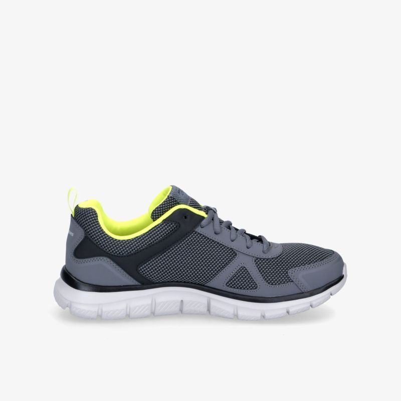 Grauer Sneaker mit neonfarbenem Akzent, atmungsaktivem Mesh-Material und flexibler, rutschfester Sohle.