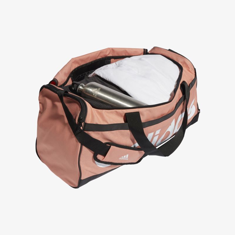 Rosafarbene Sporttasche mit schwarzem Griff, optimal für Fitness und Reisen, bietet viel Stauraum.