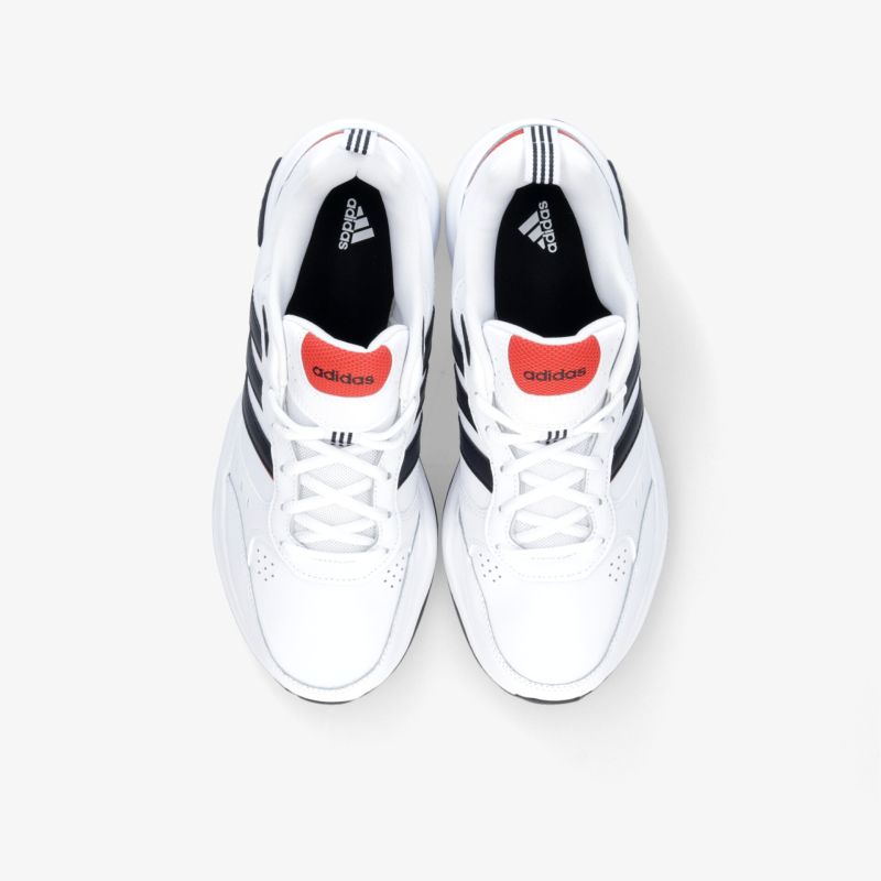 Moderner weißer Sneaker mit sportlichem Design und rotem Akzent, ideal für Komfort und Stil.