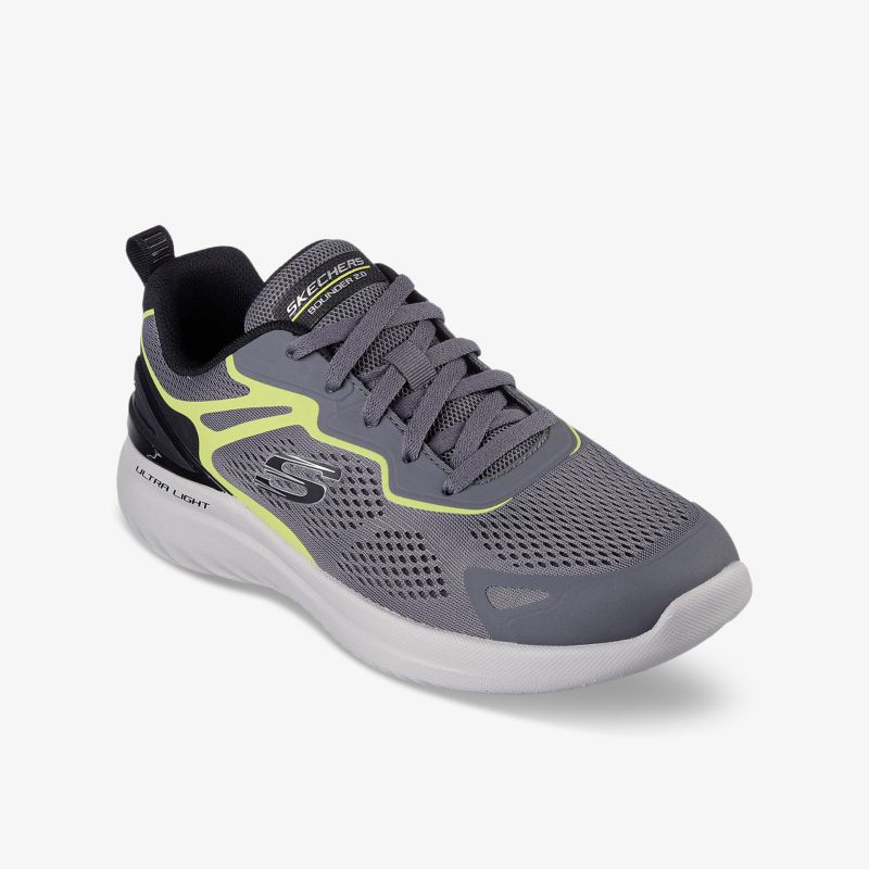 Moderner grauer Sneaker mit gelben Akzenten und atmungsaktivem Mesh für hohen Tragekomfort und stilvolle Optik.