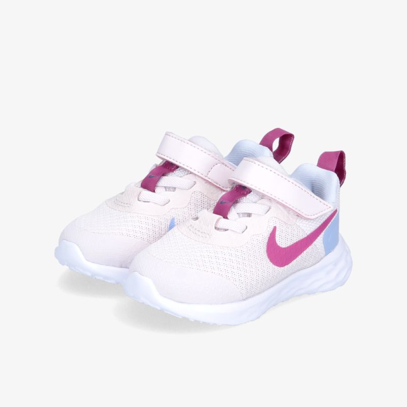 Modische und komfortable weiße Sneakers mit rosa Akzenten und praktischem Klettverschluss für aktiven Lifestyle.