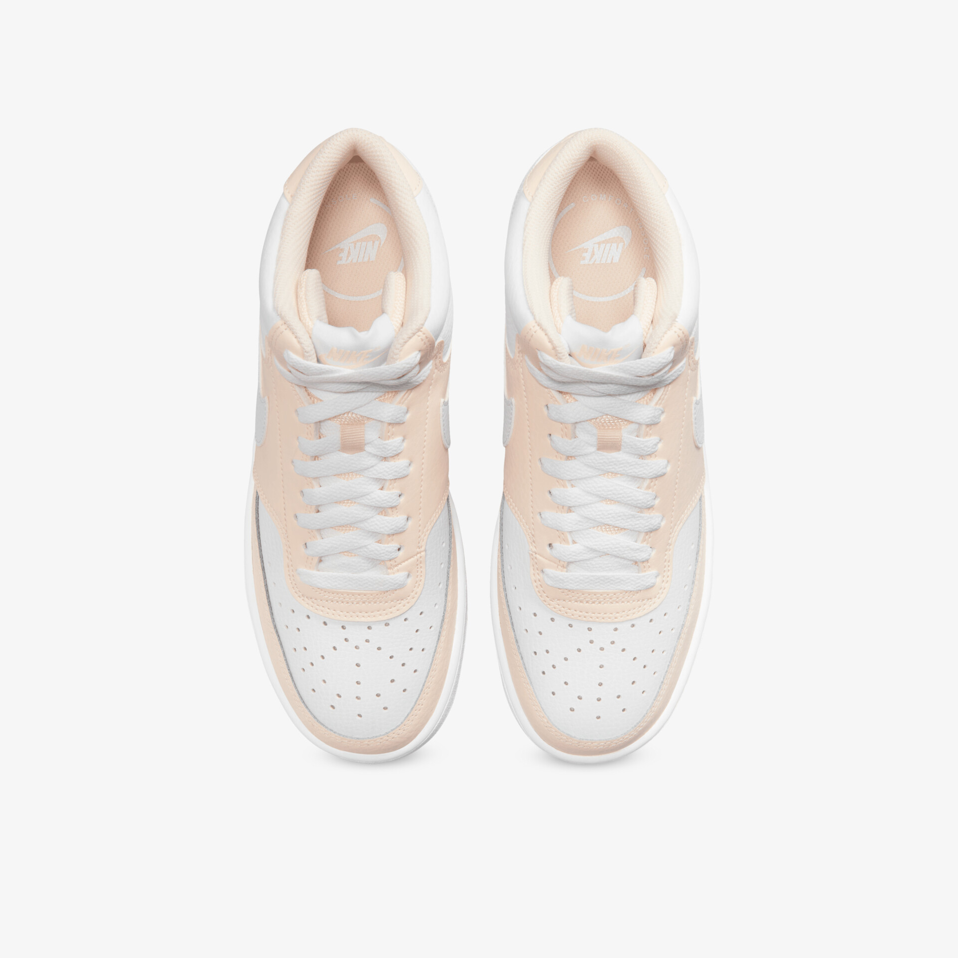 Weiße und beige Sportschuhe als Paar von oben mit Schnürsenkeln und flexiblem, leichtem Design