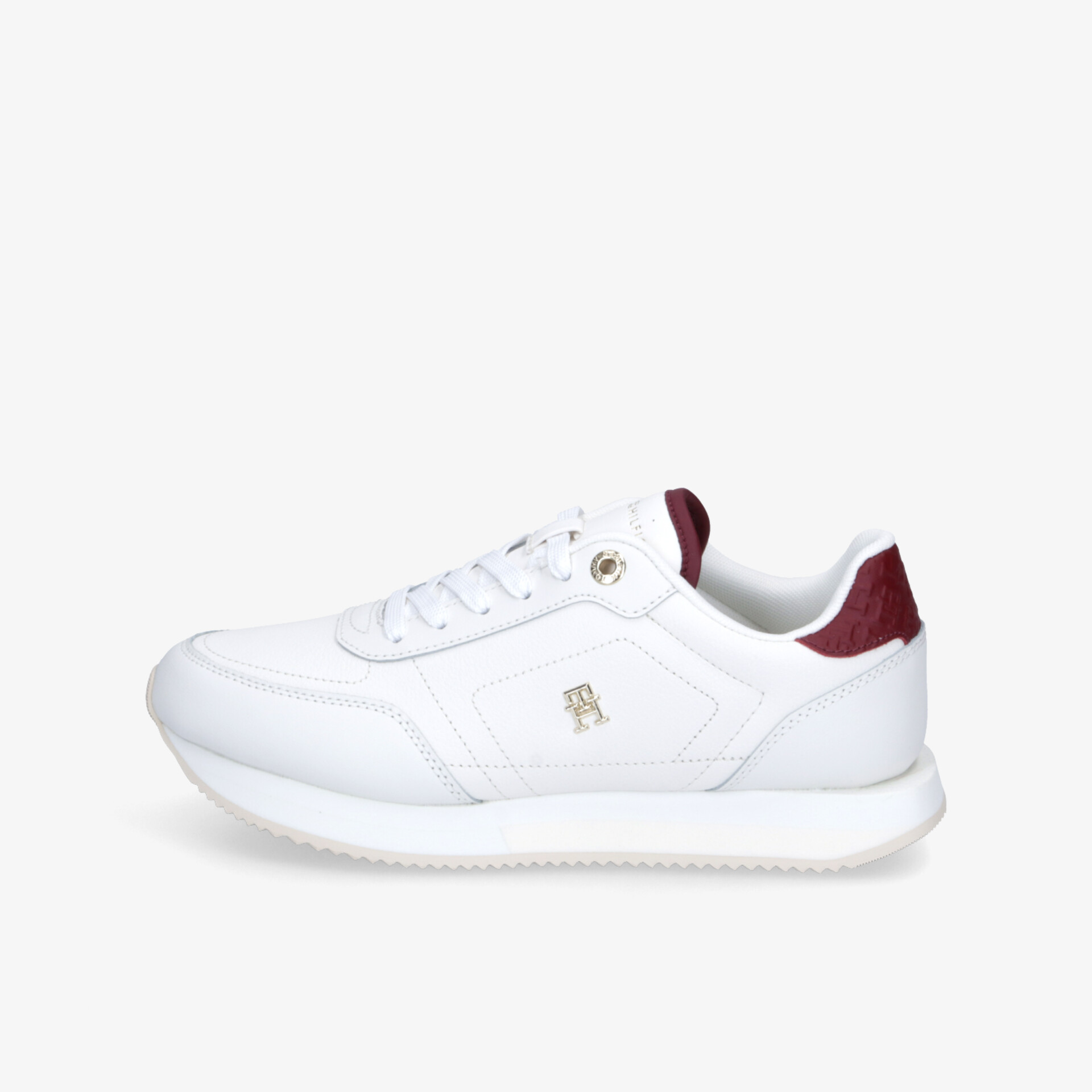Moderner weißer Sneaker seitlich mit flexibler Sohle und klassischer Schnürung, bequem und leicht