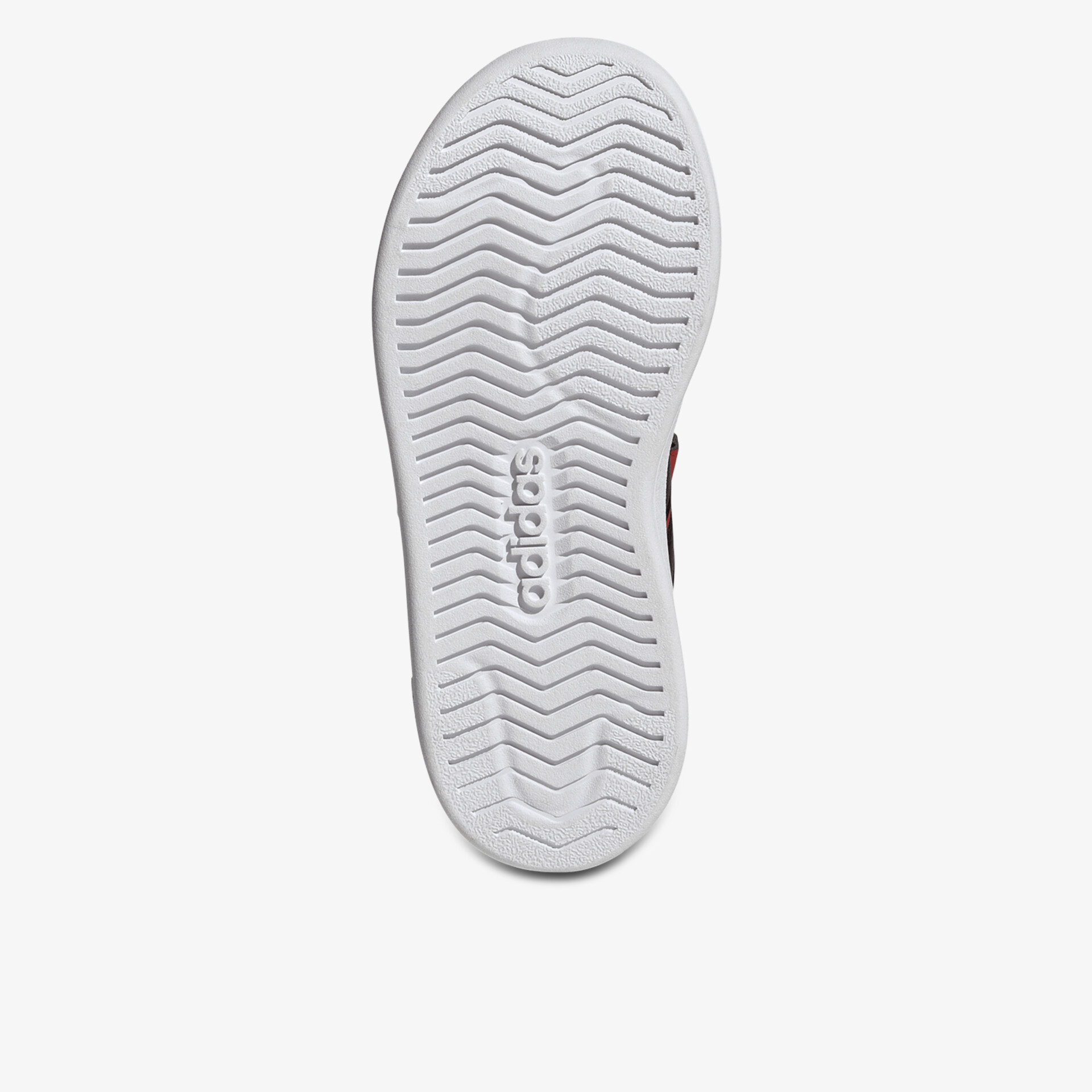 Weiße Schuhsohle mit tiefem, wellenförmigem Profil für sicheren Halt und hohe Rutschfestigkeit