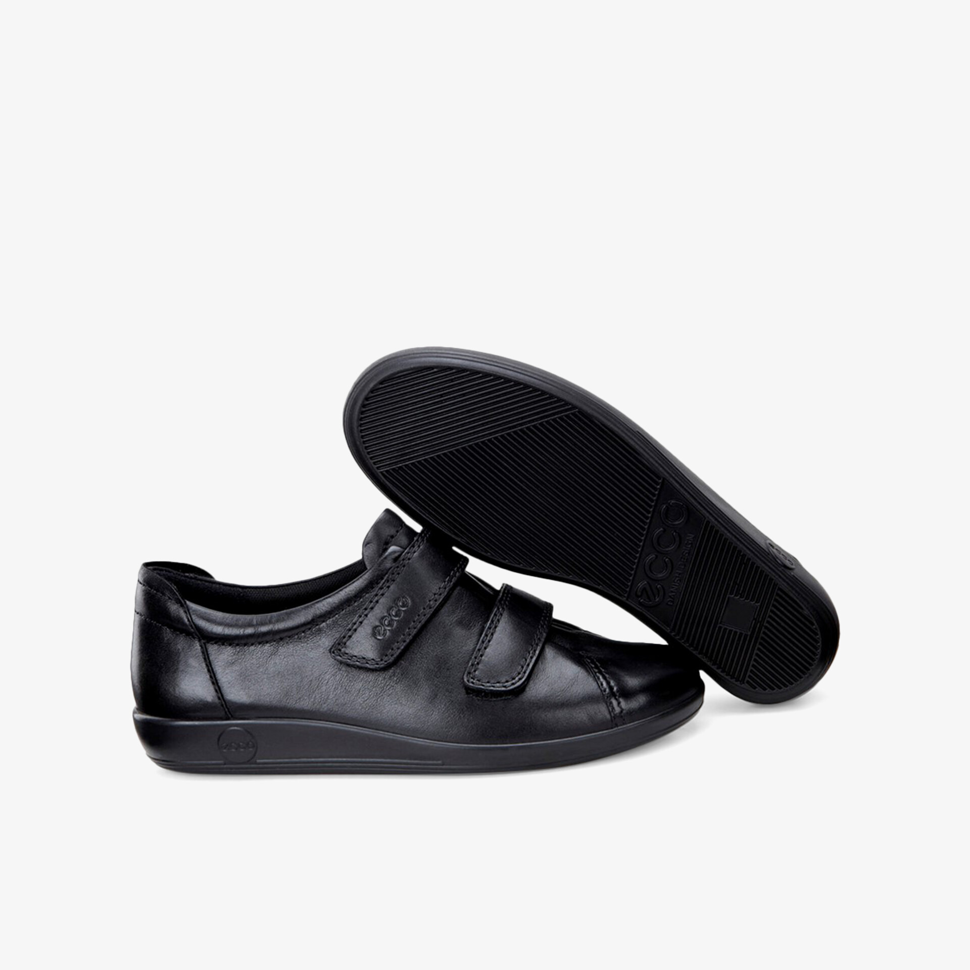 Eleganter schwarzer Schuh mit Klettverschluss und rutschfester Sohle für optimalen Komfort und Style.