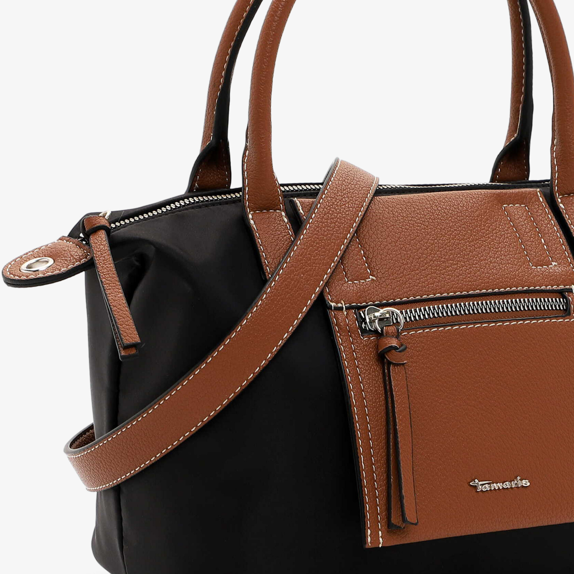 Detailansicht einer zweifarbigen Handtasche mit brauner Ledermaterial-Außentasche und sichtbarem Reißverschluss