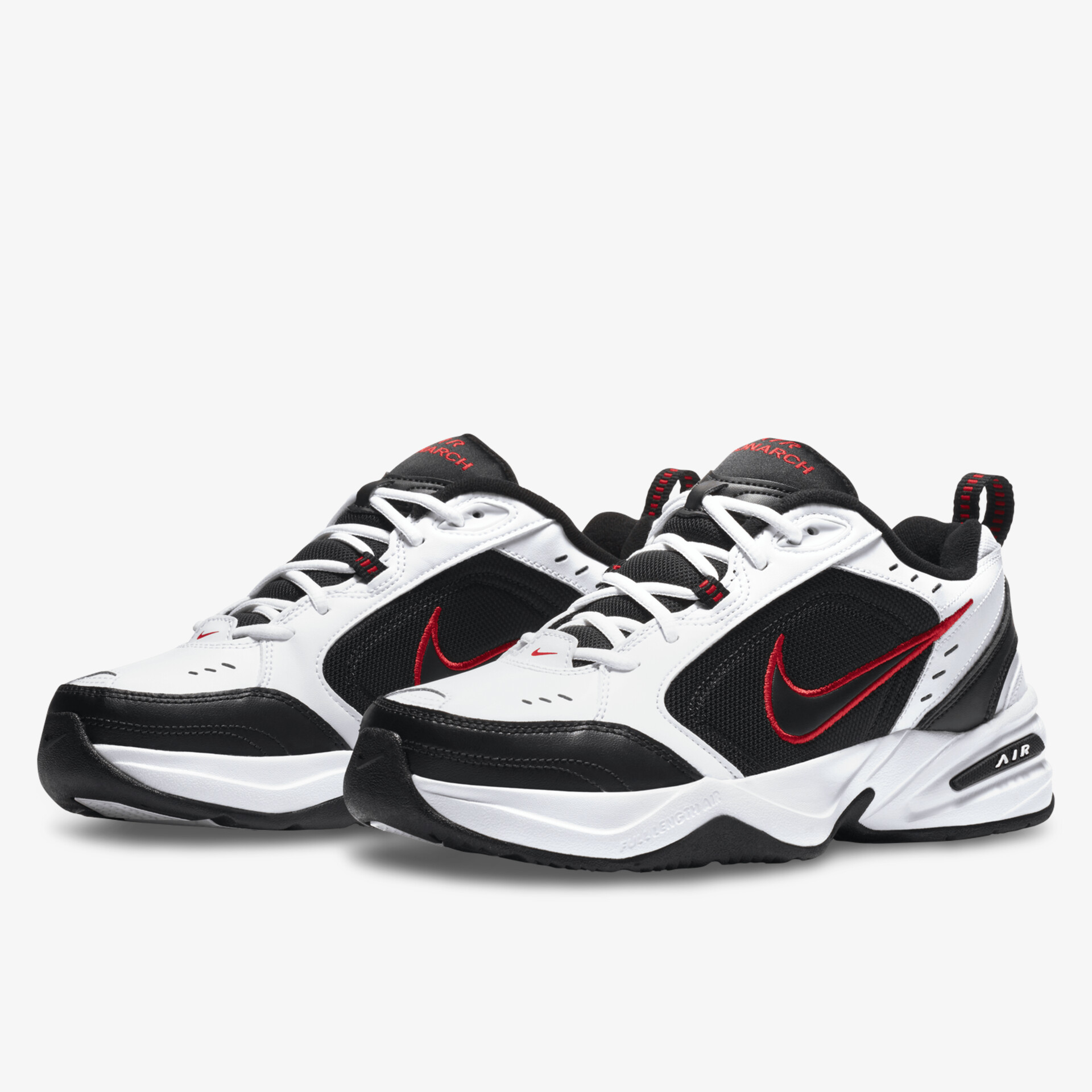 Stylische schwarze und weiße Sneaker mit rotem Akzent und hoher Atmungsaktivität für sportliche Aktivitäten.