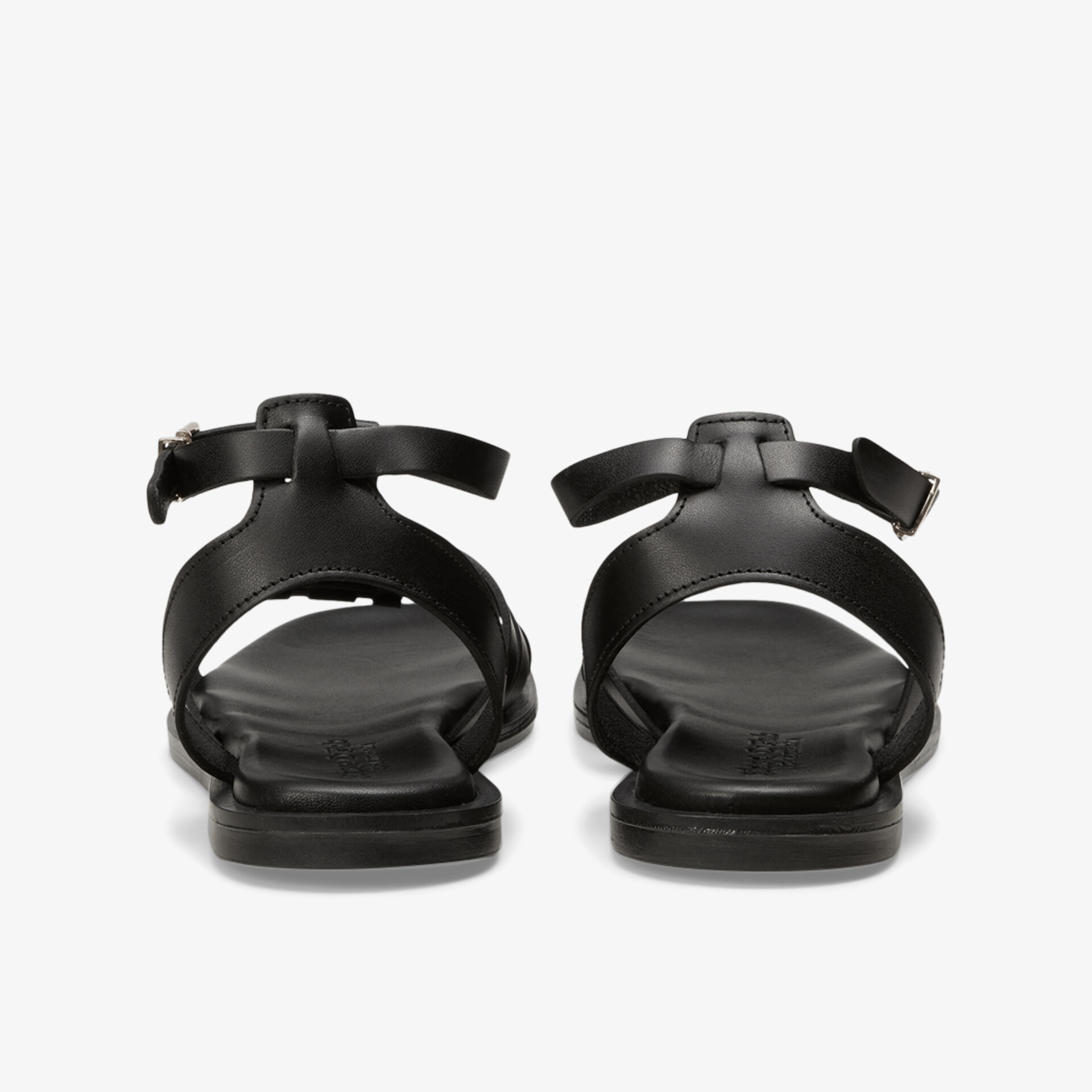 Schwarze Sandalen mit verstellbarem Riemen und flacher, flexibler Sohle komfortabel und elegant hinten sichtbar