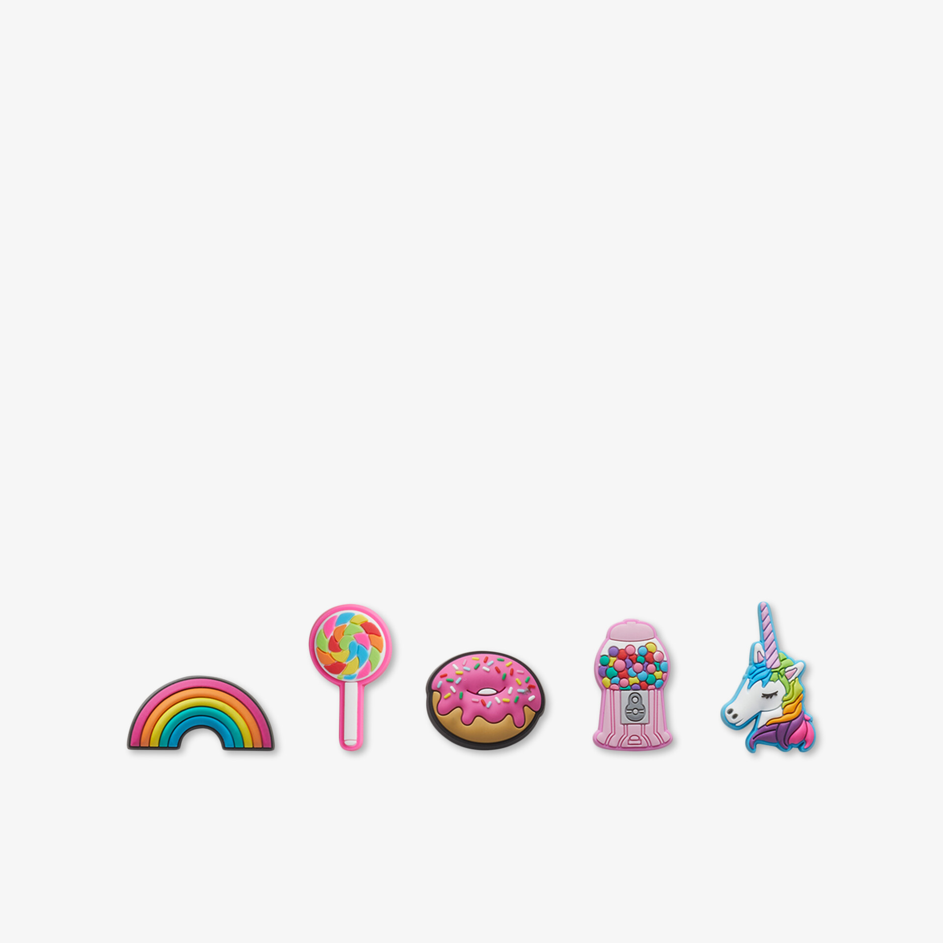 Farbige Kinderspielzeuge in Form von Regenbogen, Lupe, Donut, Musikspielzeug und Einhorn mit lebendigen Farben