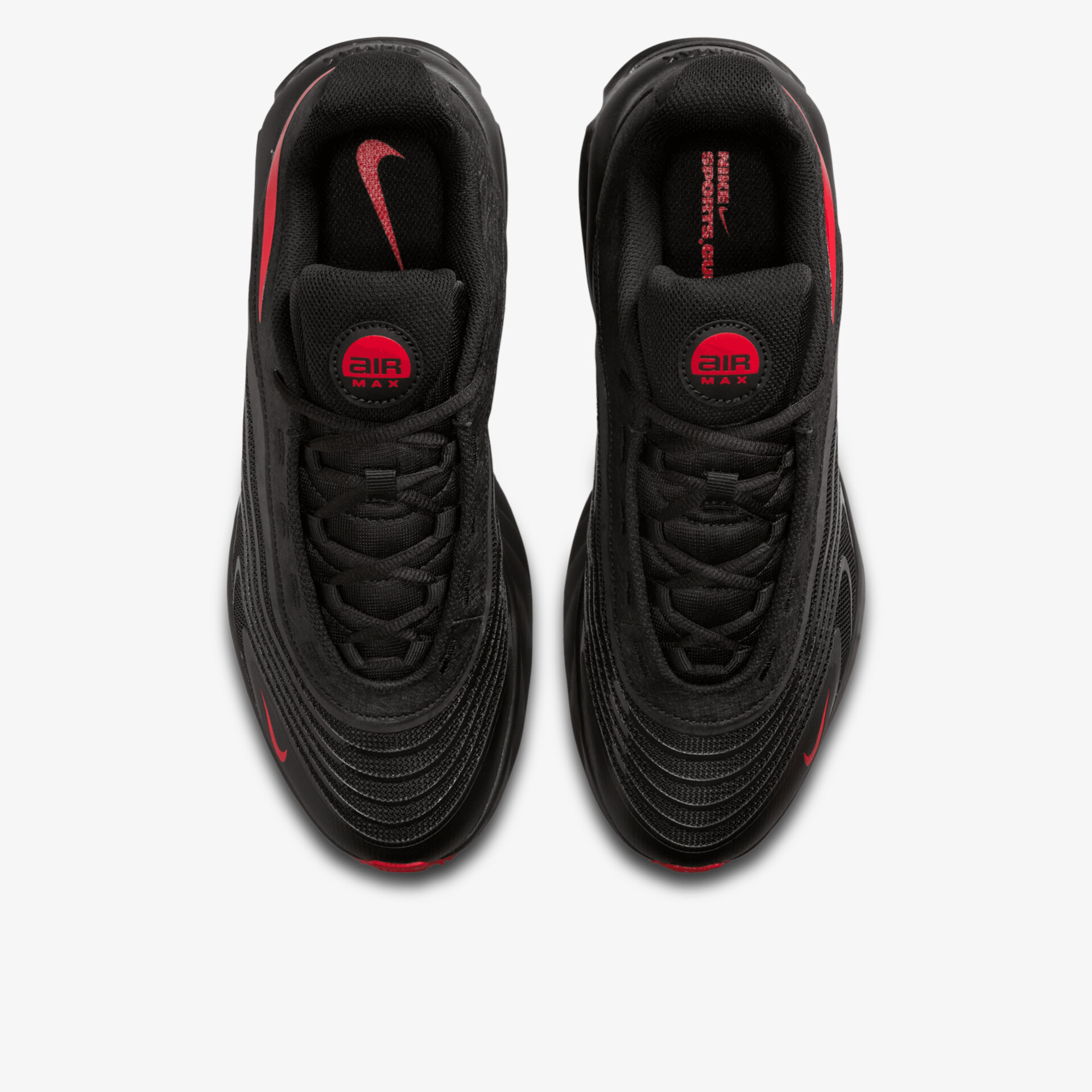 Obere Draufsicht auf zwei schwarze Sportschuhe mit rotem Logo und geschwungener Sohle