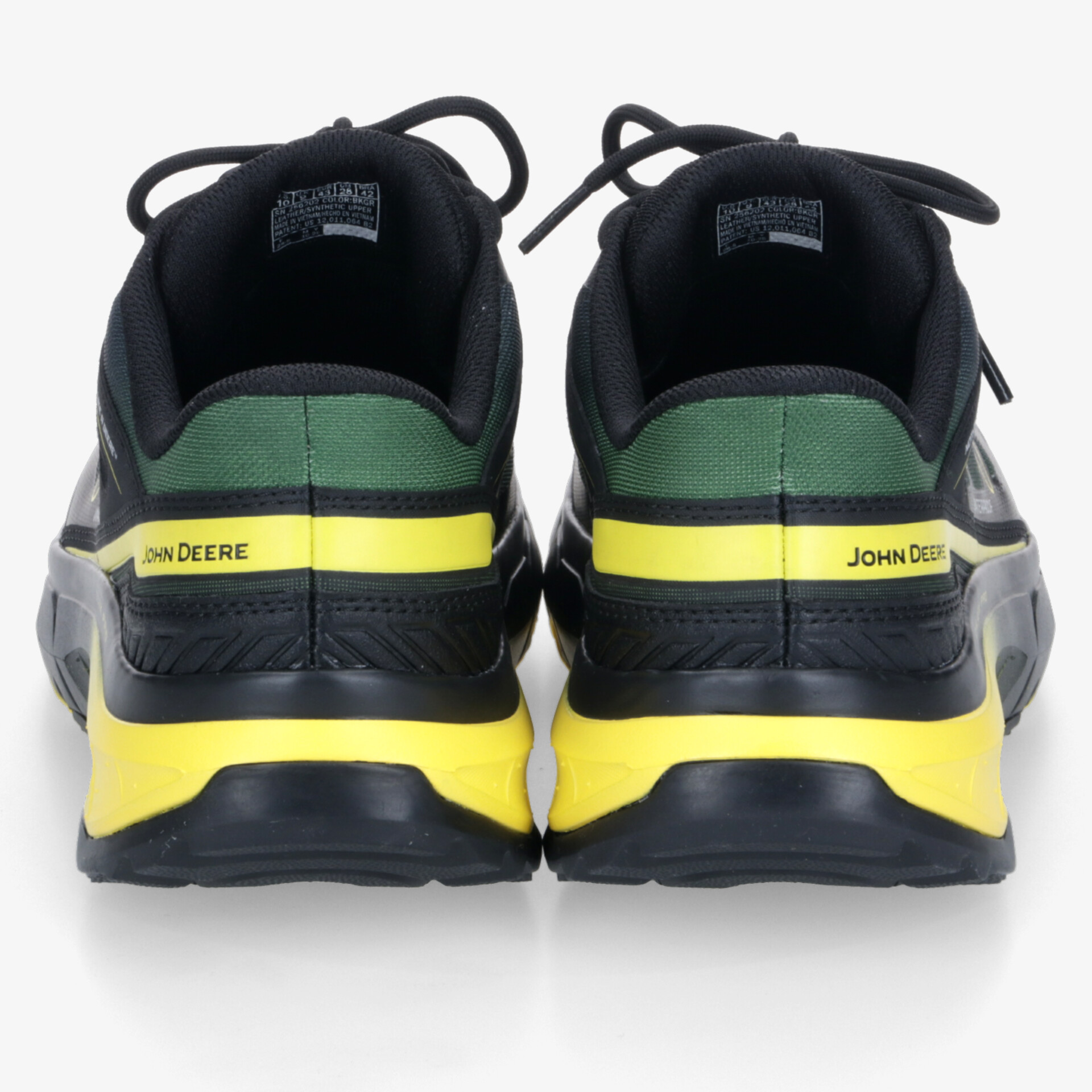 Robuster Sportschuh in Schwarz mit gelben und grünen Akzenten, stabile Rückansicht zeigt gepolsterten Komfort