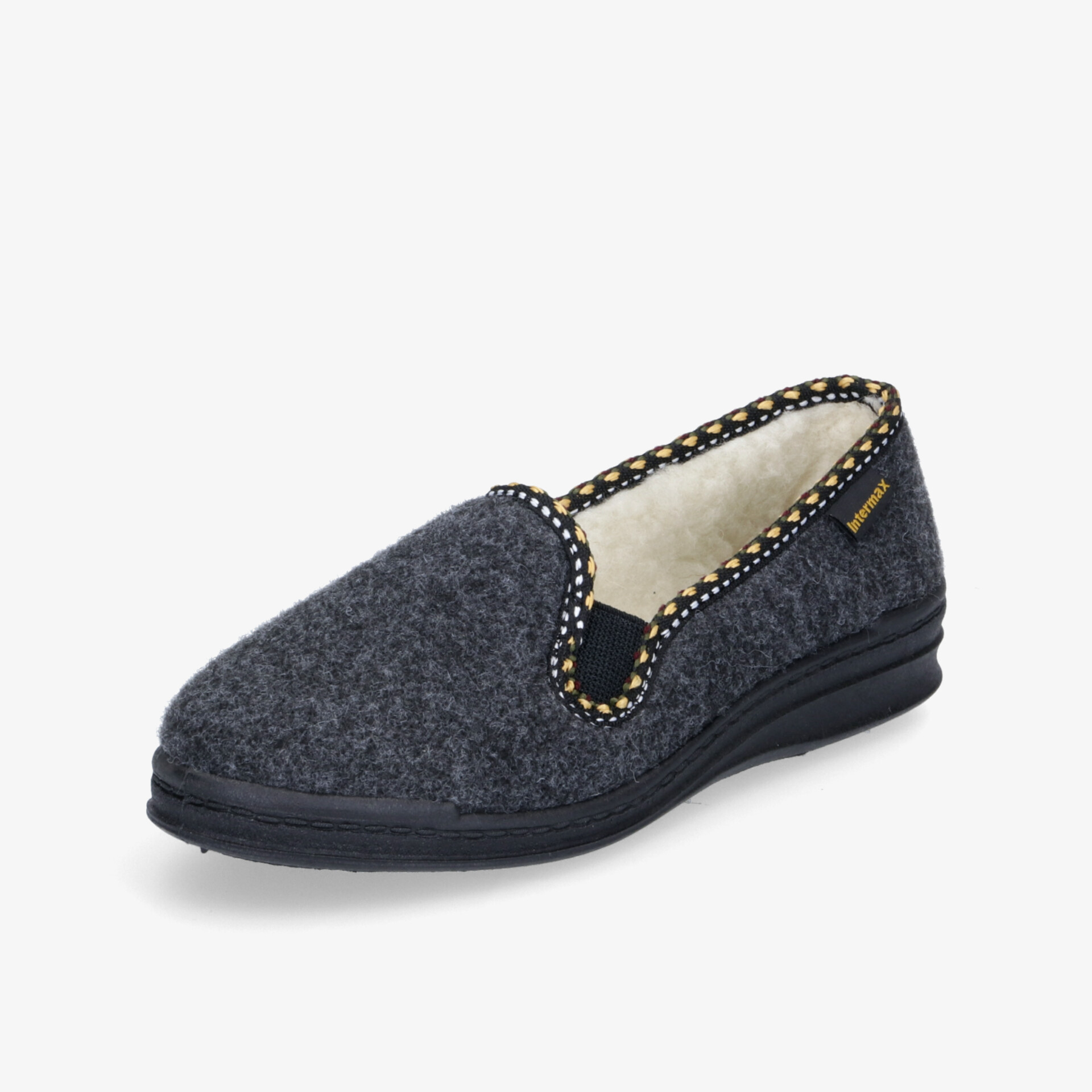 Bequemer Hausschuh in dunklem Grauton mit gepunktetem Rand und robuster Sohle.