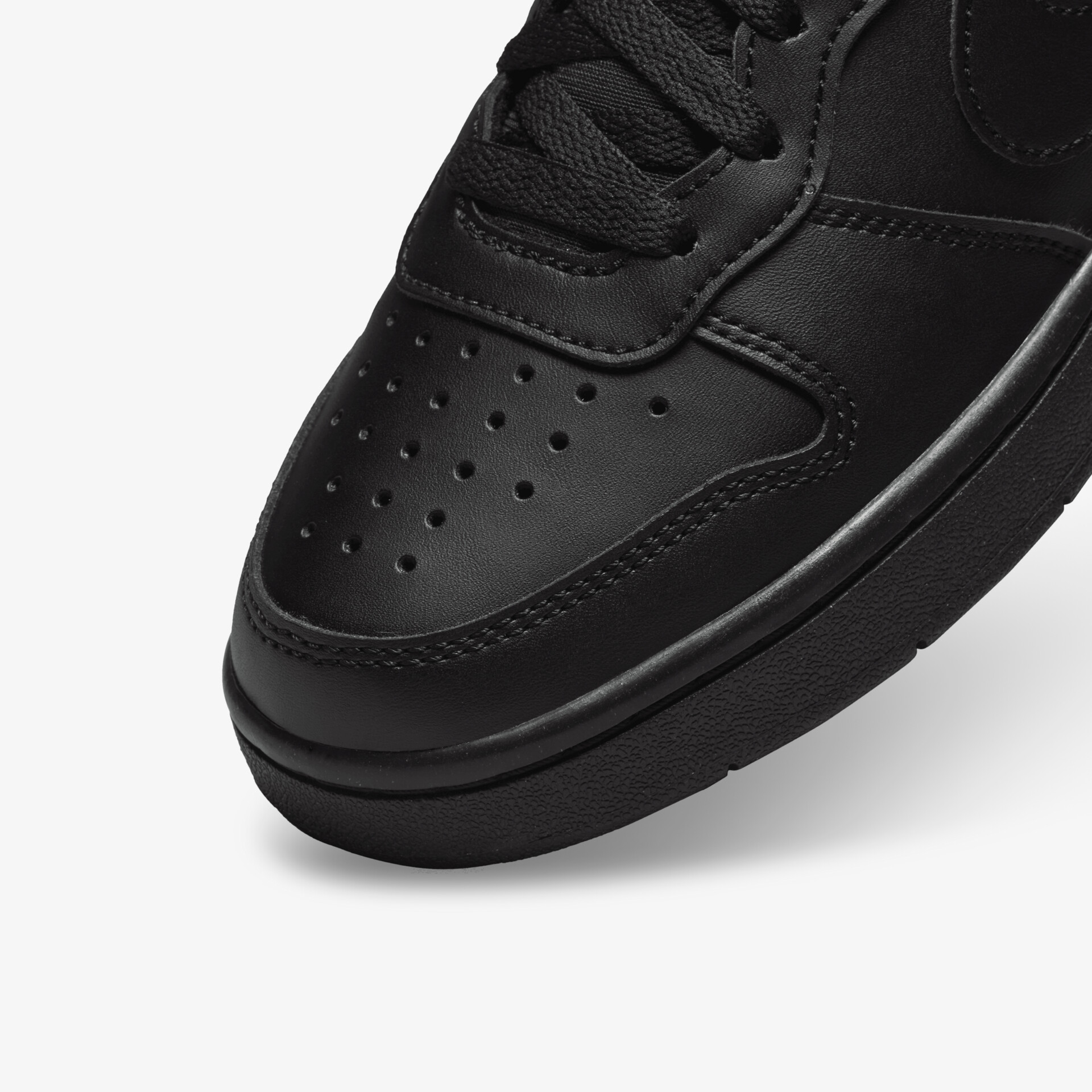 Detailaufnahme eines schwarzen Sneakers mit perforierter Oberfläche für optimale Belüftung und Komfort