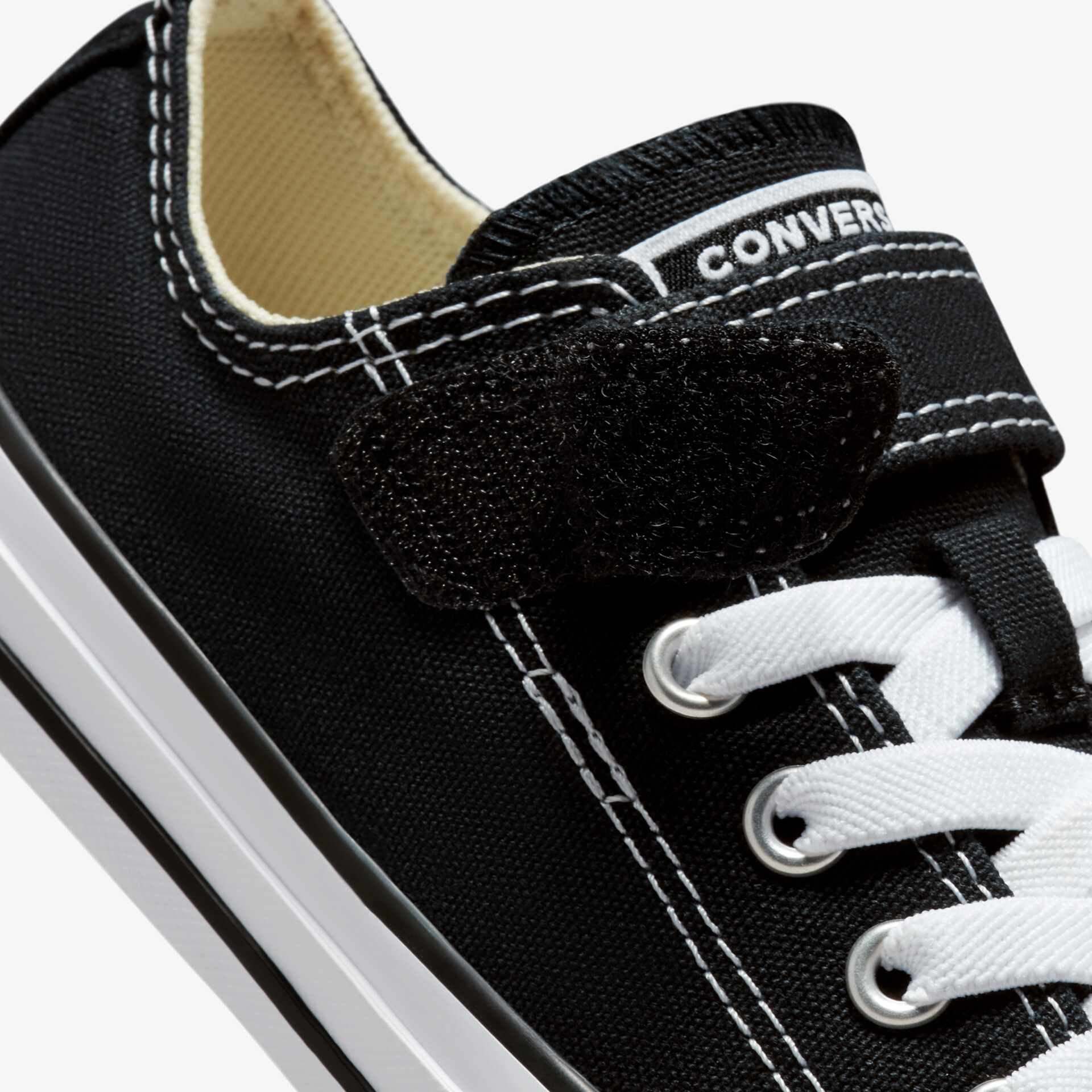 Schwarzer Sneaker mit Klettverschluss und weißer Sohle für einen sportlichen und lässigen Look.