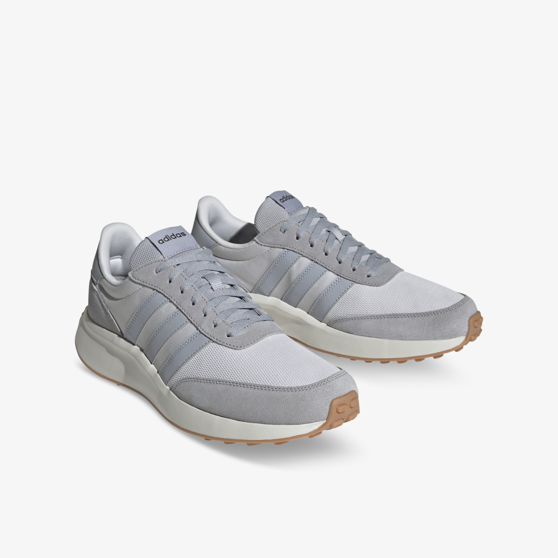 Elegante graue Turnschuhe mit weißen Sohlen und markanten Linien für optimalen Tragekomfort.