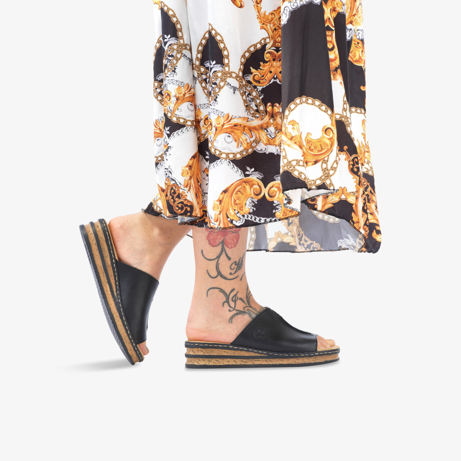 Schwarze bequeme offene Plattform-Sandale mit robuster rutschfester Sohle auf hellem Hintergrund getragen