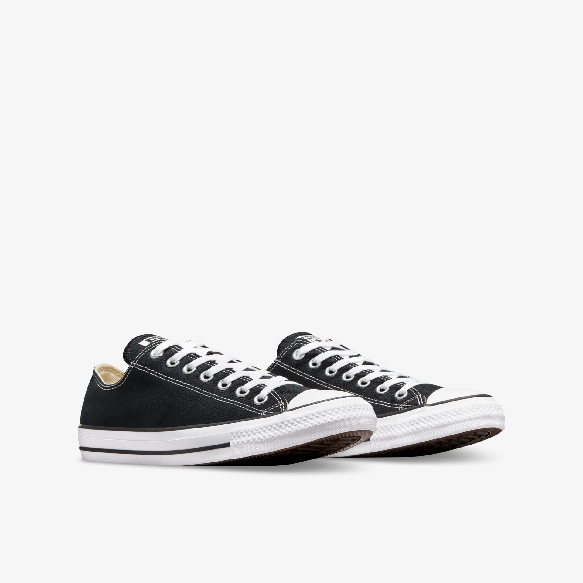 Schwarze Sneaker mit weißem Rand und Schnürsenkeln in schräger Frontansicht, sportlich und bequem