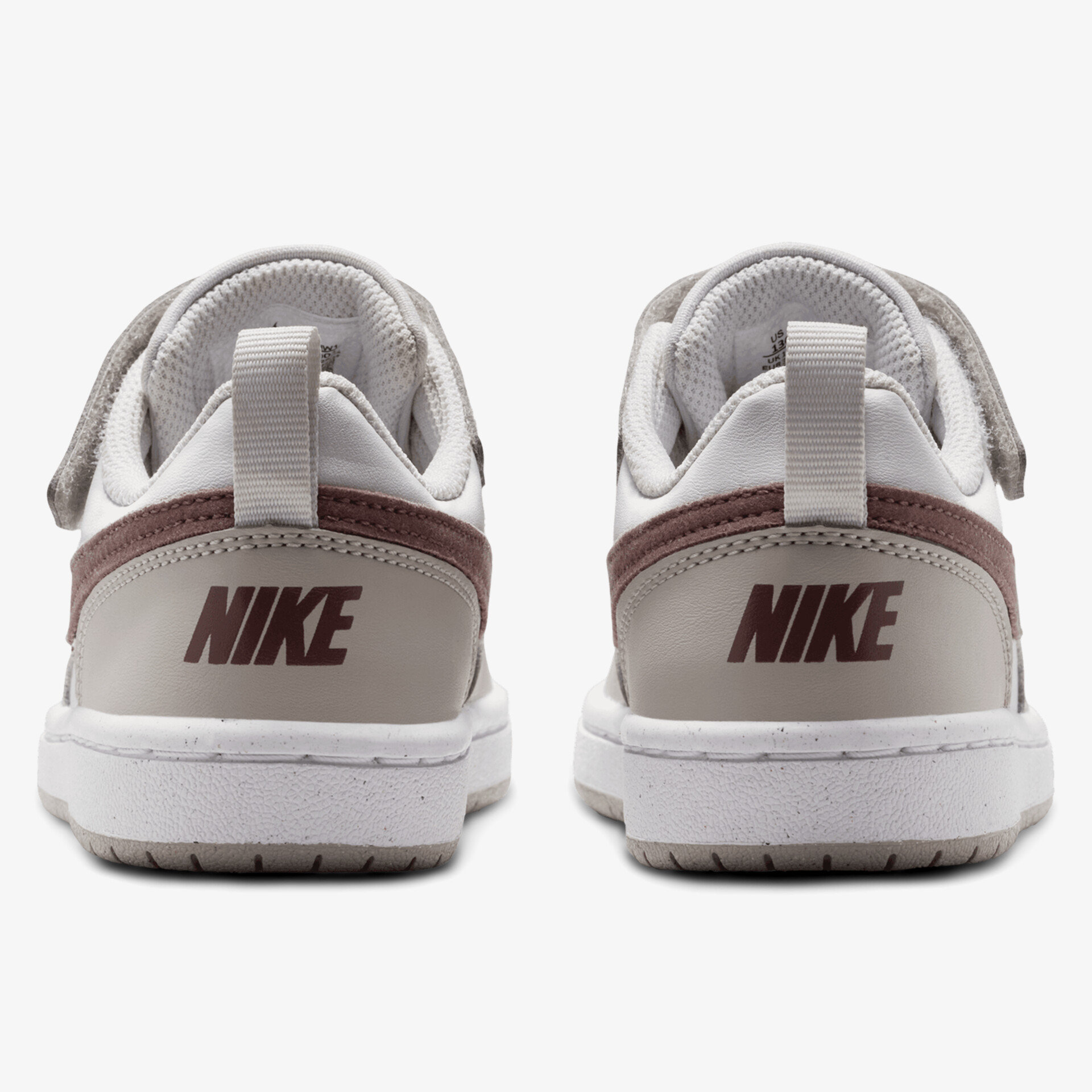 Rückansicht von weißen und braunen Sneakers, starker Markenaufdruck auf den Fersen.