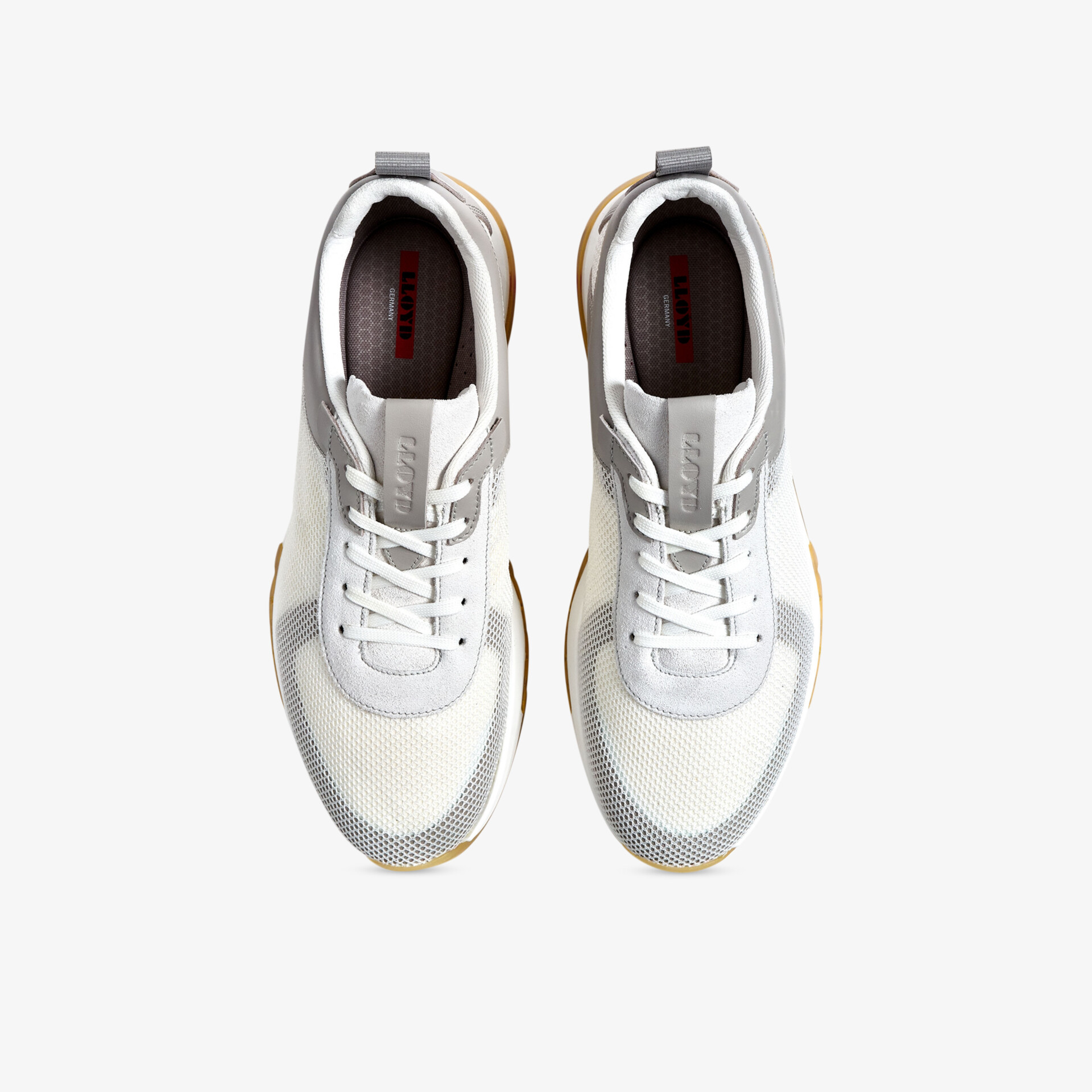 Weiße und graue Sneakers mit modernem Design und sportlichem Komfort aus der Vogelperspektive