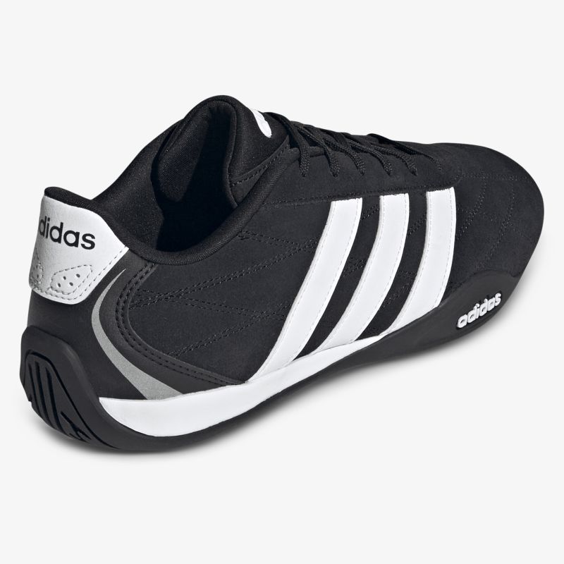 seitliche Ansicht des schwarzen Sportschuhs mit weißen Streifen, leichter Schuh mit rutschfester Sohle