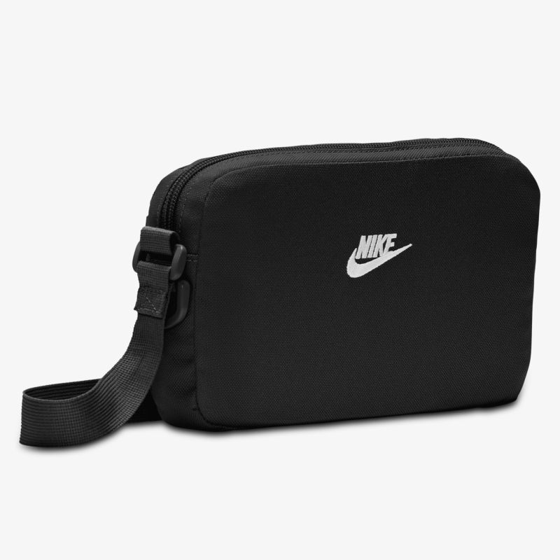 Kompakte und stilvolle schwarze Tasche mit verstellbarem Gurt und klassischem Design.