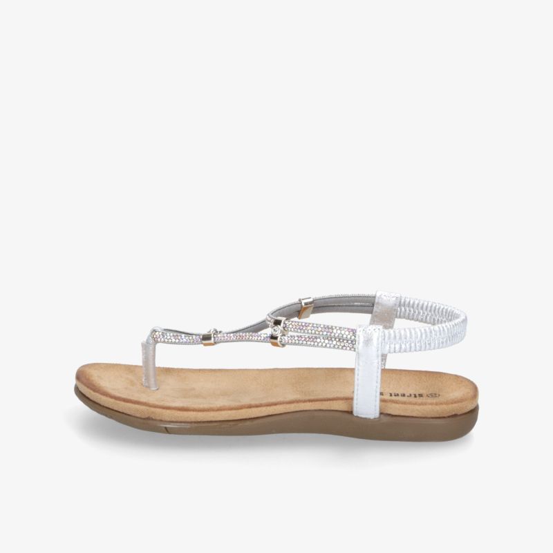 Seitliche Ansicht einer flachen Ledersandale mit verstellbarem Riemen und bequemer Sohle