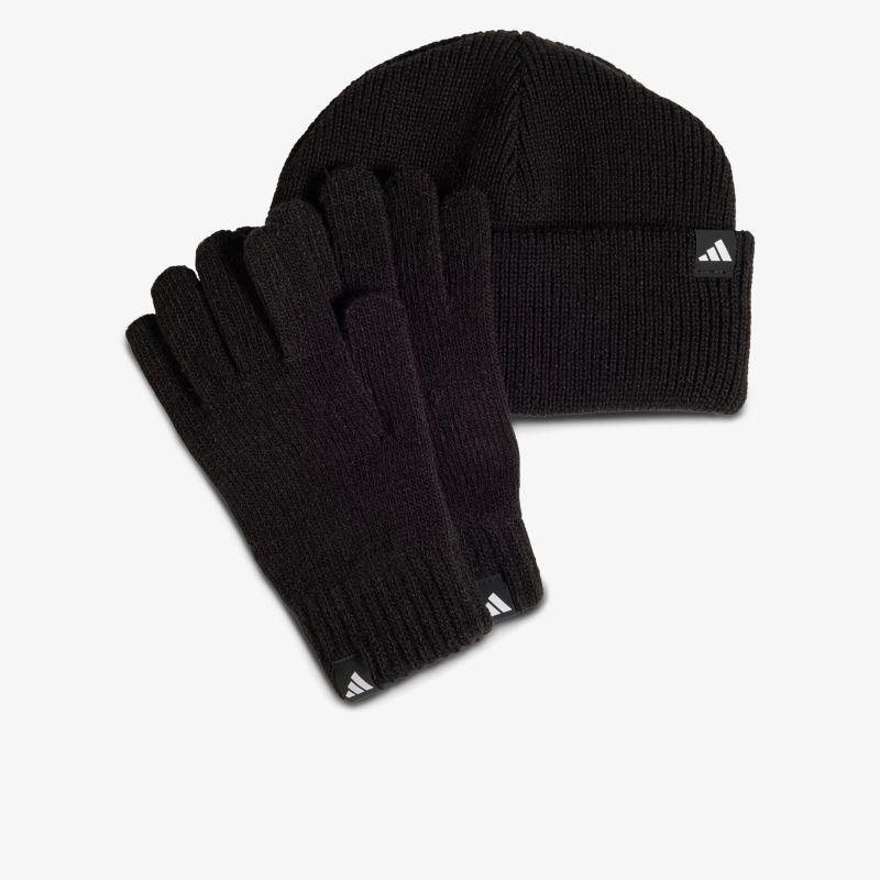 Schwarze gestrickte Mütze und Handschuhe aus weichem, warmem Material für kalte Tage