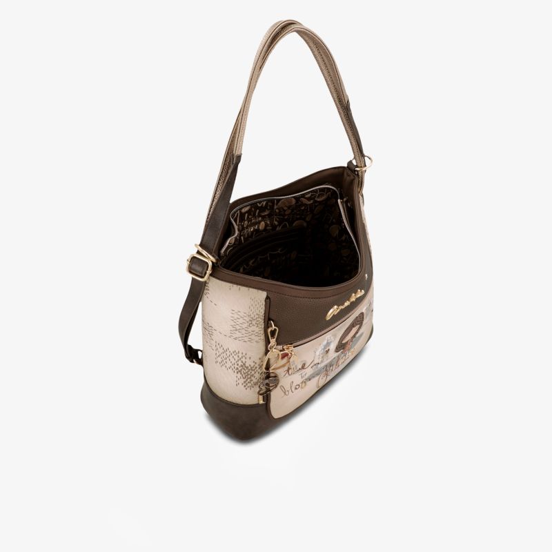 Brown handbag with adjustable strap and zipper closure, spacious interior for everyday use