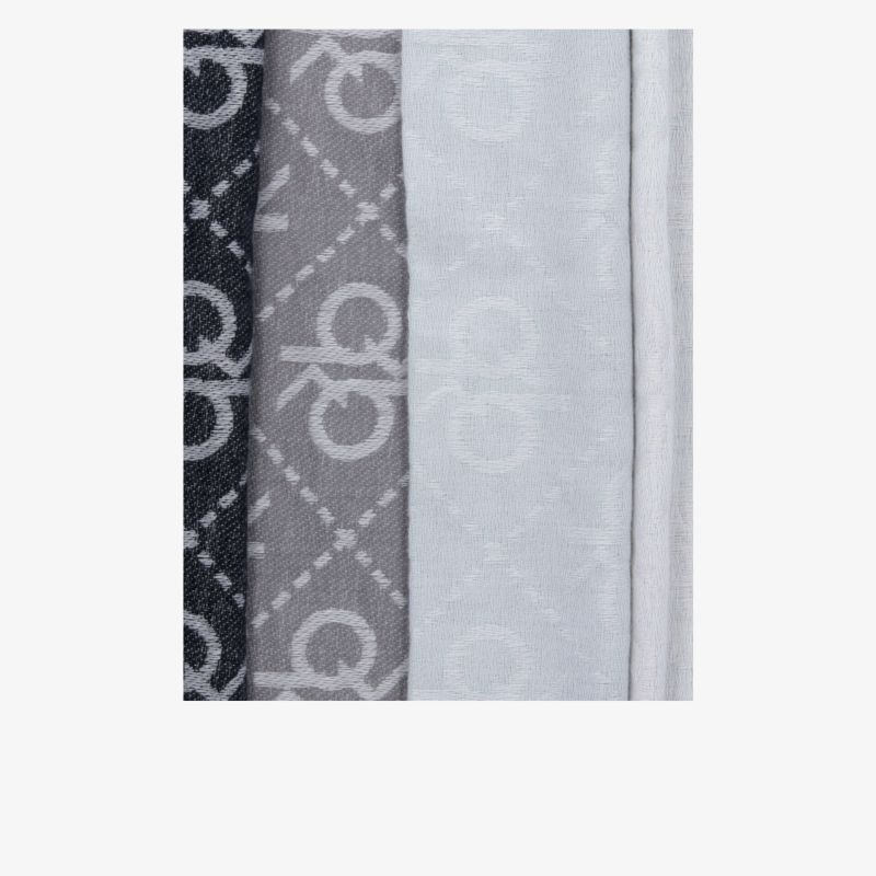 Drei Stoffmuster in Schwarz, Grau und Weiß mit hochwertiger feiner Linienstruktur und elegantem Design