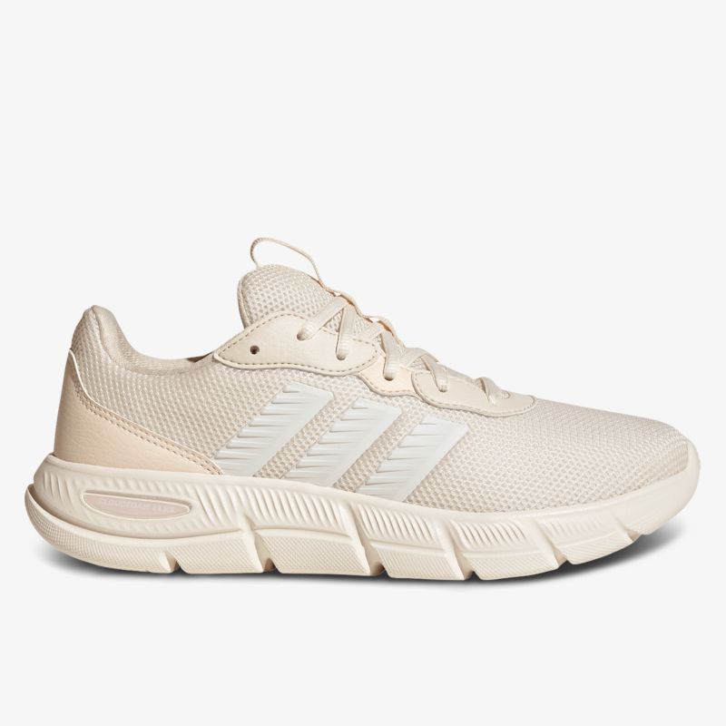 Beiger sportlicher Sneaker mit atmungsaktivem Material und flexibler, rutschfester Sohle in klarer Seitenansicht