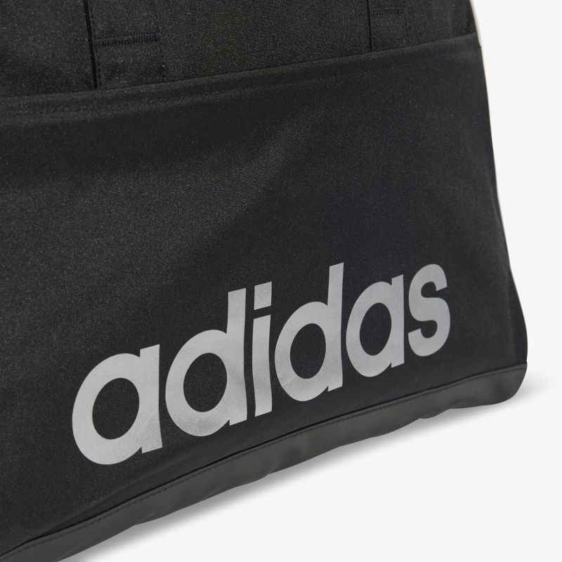 Detailaufnahme des klaren adidas Logos in prägnanter Schrift auf schwarzem Hintergrund