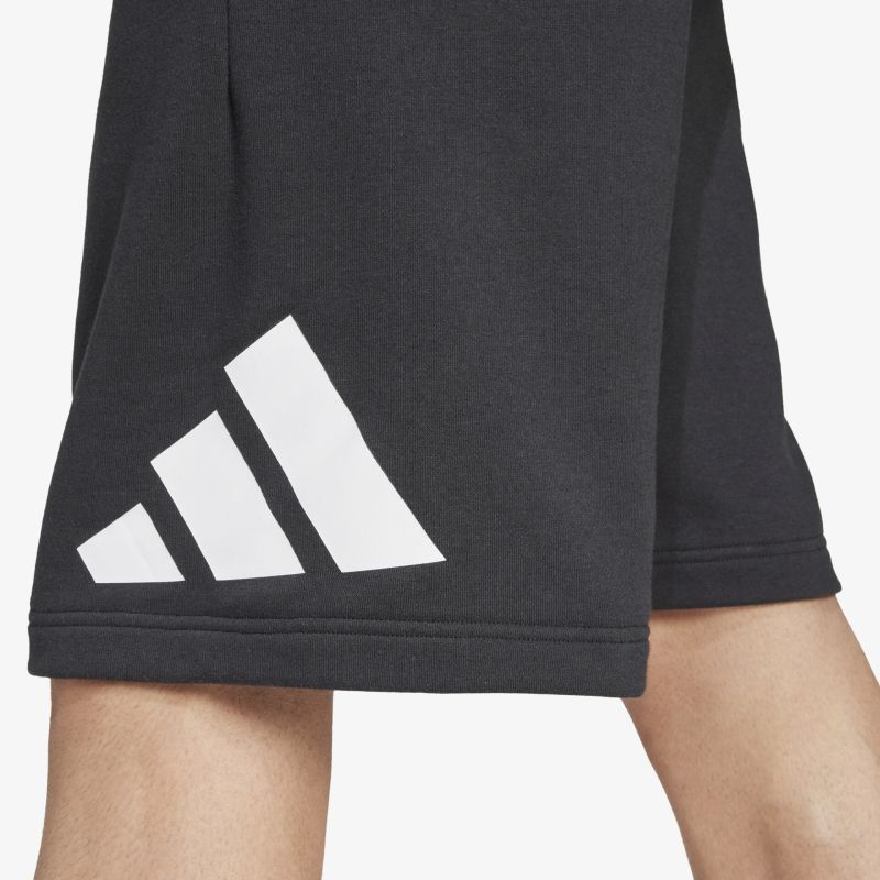 Detailaufnahme des weißen Adidas Logos auf schwarzem, elastischem und atmungsaktivem Shorts-Material