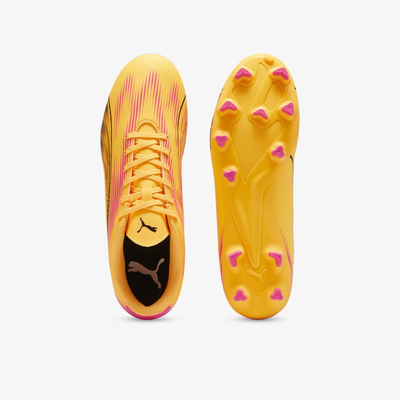 Fußballschuh mit gelber oberfläche und pinken nagelähnlichen noppen für optimalen halt und beweglichkeit