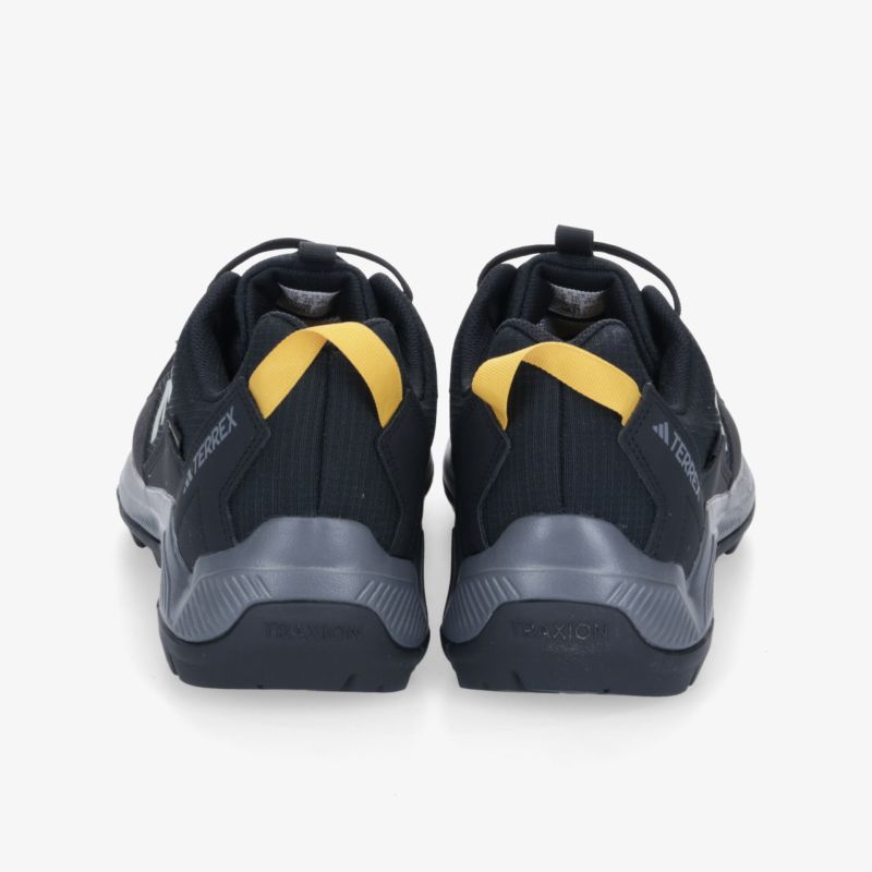 Rückansicht von schwarzen Sportschuhen mit gelben Akzenten, ideal für Sport und Freizeit.