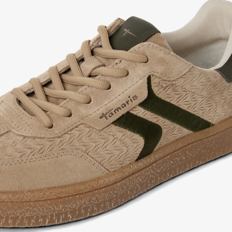 Beiger Sneaker mit grünen Akzentstreifen, strukturierter Oberfläche und komfortabler Sohle, moderner sportlicher Schuh