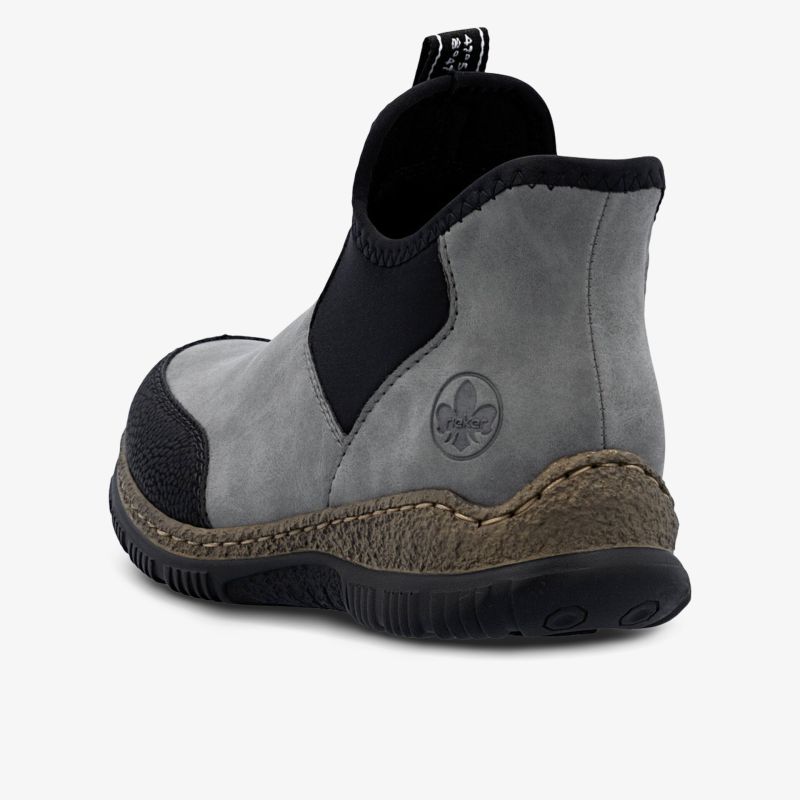 Robuster grauer Schuh mit elastischem Einsatz und profilierter rutschfester Sohle, ideal für Alltag