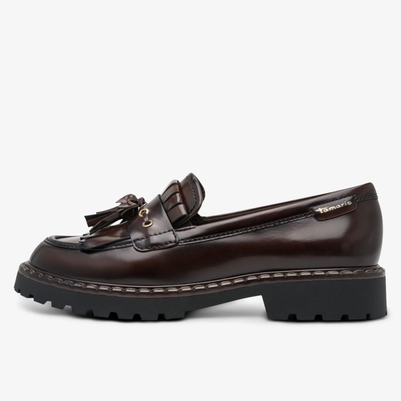 Seitliche Ansicht eines robusten dunkelbraunen Loafers aus Leder mit profilierter Sohle und modischem Quasten-Detail